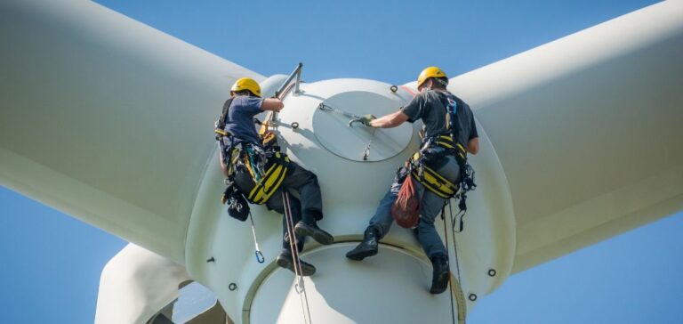 Technicians on top of a wind turbine for repairs