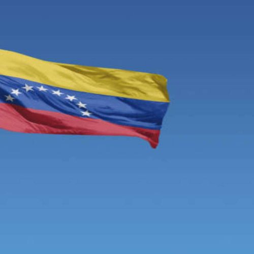 Flag of Venezuela in front of a clear blue sky